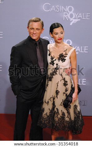 BERLIN - NOVEMBER 21: Daniel Craig and his girlfriend Satsuki Mitchell smile at photographers during German premiere of James Bond film \