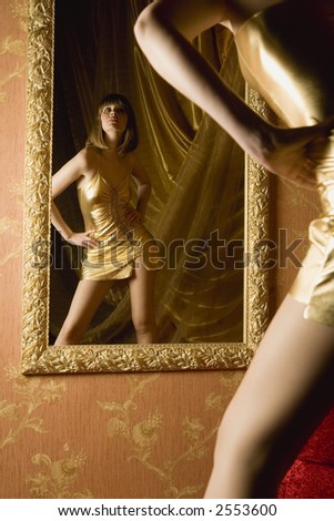 stock photo : Portrait of woman in gold dress in interior