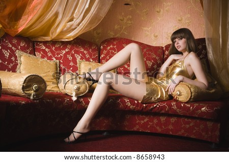 stock photo : Portrait of woman in gold dress in interior