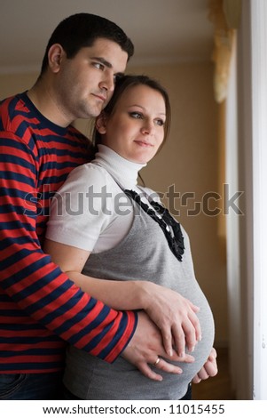 Beautiful young happy family expecting a baby
