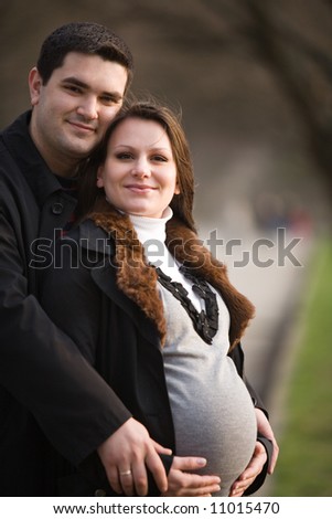 Beautiful young happy family expecting a baby