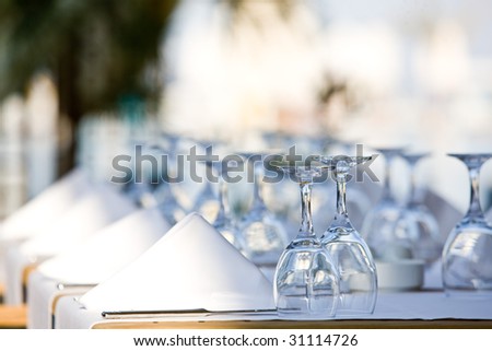 a line of wine glasses fading off in the distance, shallow depth of field.