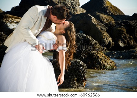 stock photo happy young and attractive wedding couple on the beach
