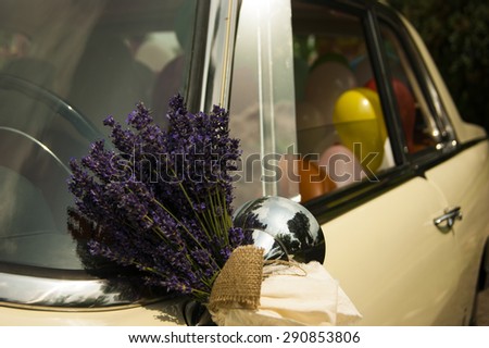 Lavender and balloons on bridal vintage car