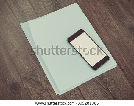 Blank stationery set on wood background paper, watch, phone, sheets and pen. Business mockup template identity