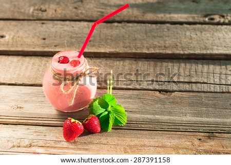Drink smoothies summer strawberry on old wooden table.