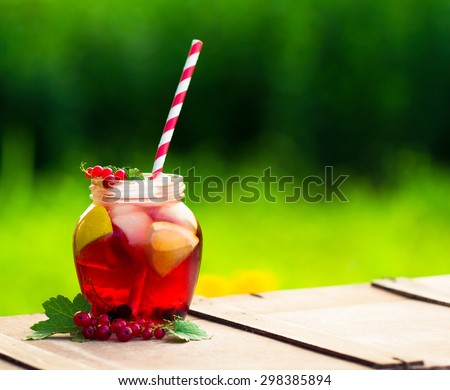 Iced Red currant drink on wooden table