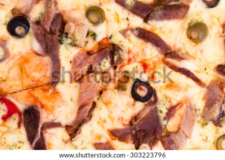 Hot pizza with meat, tomatoes and olives