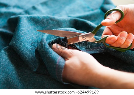 Tailor. Man Hands notch tailor tailor\'s scissors cloth. Close Up.