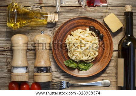 Mock Up. Wine. Pasta. Cherry tomatoes. Top view. Closeup. Spices. Italian food ingredients on wooden background.