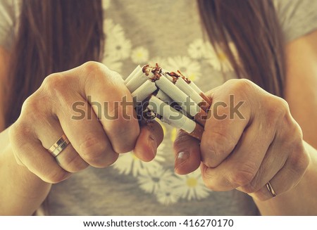 Quit smoking cigarettes. A young girl breaks a cigarette