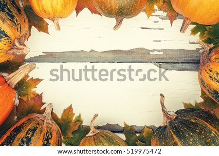 Thanksgiving. Toned image. Ripe pumpkin and autumn fallen leaves on a white vintage board. Decorated background, greeting card Thanksgiving Day. Happy Thanksgiving Day!