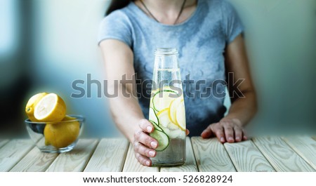 Detox. healthy eating, drinks, diet, detox and people concept - close up of woman with fruit water in glass bottle