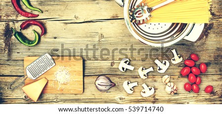 Ingredients on a wooden table. Ingredients for cooking pasta, spaghetti, fettuccine, closeup,