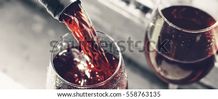 valentine\'s day, date, love, Celebration. pouring red wine. Wine in a glass, selective focus, motion blur, Red wine in a glass. Sommelier pouring the wine into the glass. Thanksgiving Day