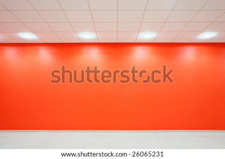Red wall and white ceiling with lights on