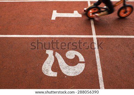 Running track and movement of kid rider with balance bike, to be the winner
