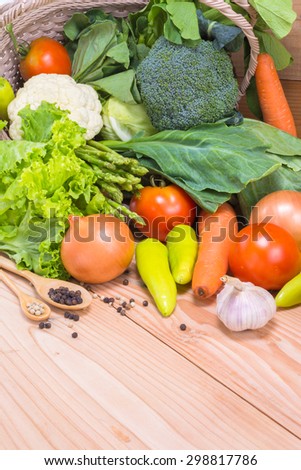 Fresh vegetable in basket with wooden background