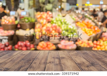 Empty wood table top on blurred market fruit. can montage or display your products