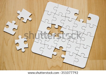 Incomplete white puzzle with three pieces left