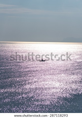 Boat sailing in the gazing sun on the Mediterranean Sea.