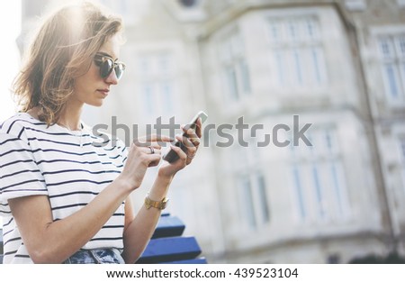 Hipster texting message on smartphone or technology, mock up of blank screen. Girl using cellphone on building castle background close. Tourist female hands holding gadget on blurred backdrop. Mockup