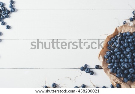 Blueberries on vintage wooden white background top view, healthy food on dark table mockup, berry for smoothie on vintage rustic country board, fresh bilberry mock up closeup, copy space for text
