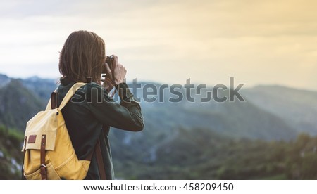 Hipster young girl with bright backpack taking photo of amazing landscape sunset on vintage camera on peak mountain mockup. Tourist traveler on background sunlight in trip in northern Spain