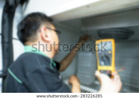 Blurred Background - HVAC Engineer checking cold room