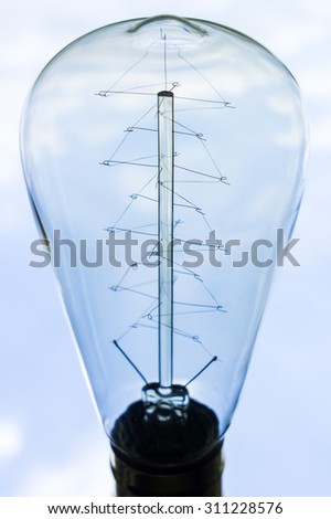 Abstract Vintage Light Bulb Look Like Christmas Tree Over Light Blue Sky With Clouds