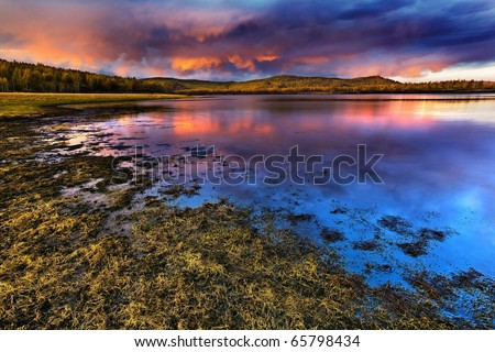 Sunset under the lake and forest