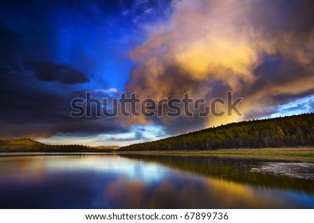 Sunset under the lake and forest