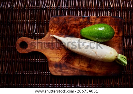 Horseradish and avocado on the vintage table, creative picture of fresh veggies