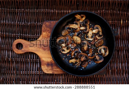 Fresh mushrooms collected in the forest fried in a deep frying pan,mushroom protein source,space for text