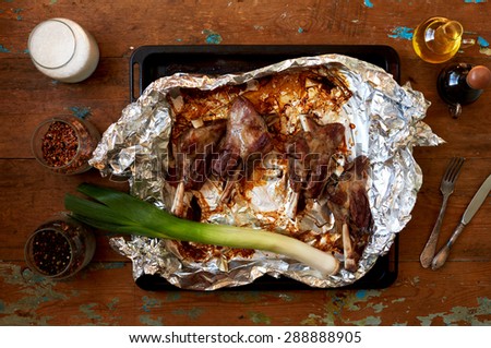 lamb shank cooked in a pan at home in the oven and wrapped in foil, olive oil and  sauce give juicy dish, utensils for roasting meat in her excellent fry thoroughly, Sea salt is ideal for meat dishes
