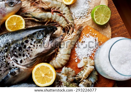 Fishermen brought in an expensive fish restaurant carcass fresh salmon and tiger prawns, cook restaurant immediately started to marinate seafood for future cooking
