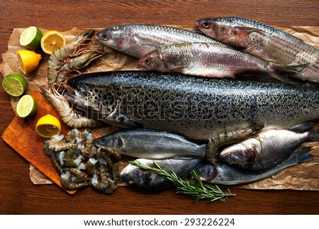 Big fish platter on the counter fish restaurant. Fresh shrimp and salmon carcass decomposed into brown parchment paper