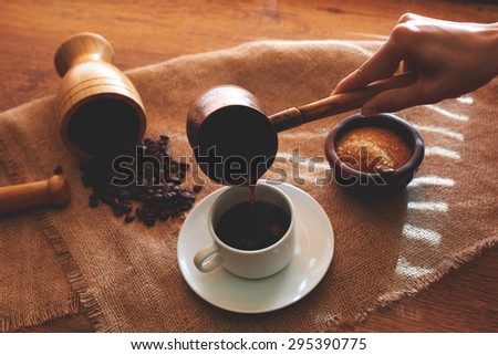 Morning coffee for her husband, the wife served on linen fabric in the color table