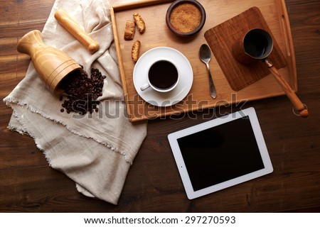 Interesting supply of coffee in the coffee shop, on a large wooden platter with brown sugar and crunchy biscuits on the tray is as a cezve with the remaining brewed coffee