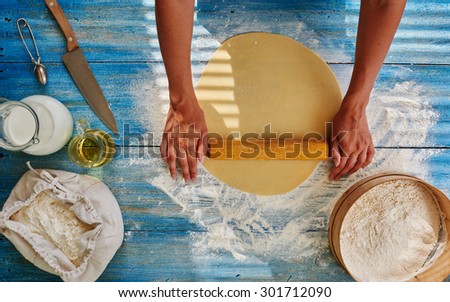 Cook in a trendy Italian restaurant rolls the dough to cook from Spaghetti, Girl Roll out the dough to cook from it that pie fillings or pizza