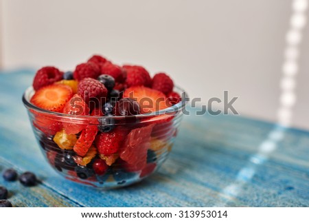 Chef cooked fresh dessert snack after a hearty main dish, cook stylish and simple salad served in a deep glass bowl a few people