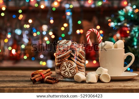 Gingerbread  with mug of hot chocolate and candy cane.