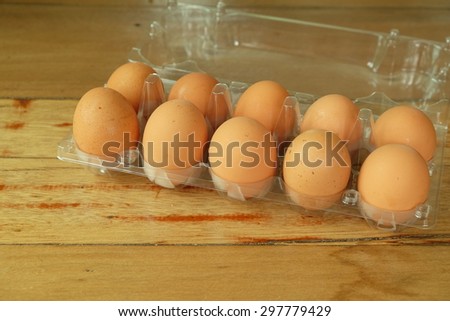 ten eggs in an egg cup on wooden table