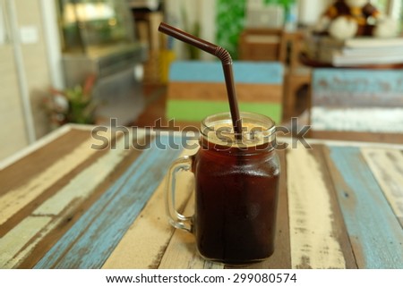 Ice black coffee on vintage wooden table