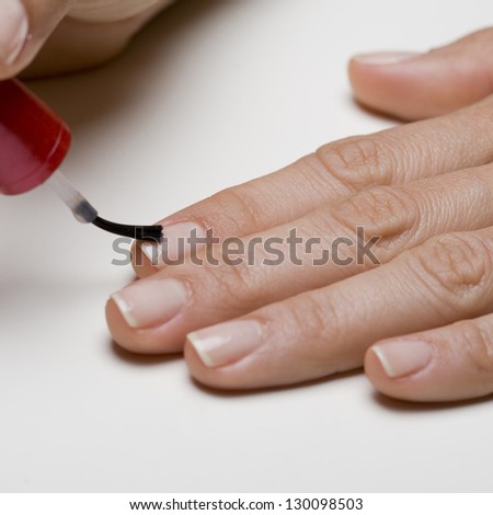 woman painting fingernails