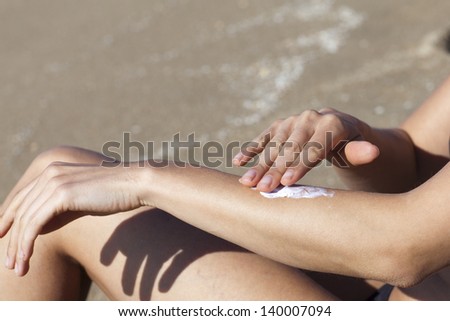 woman putting some lotion on