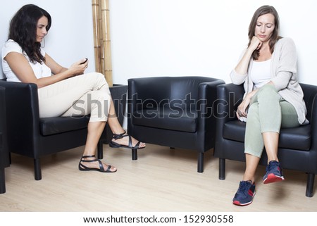 Two women waiting at doctor in waiting room