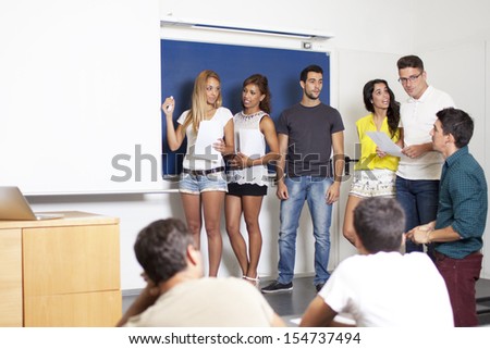 professor with students making a presentation