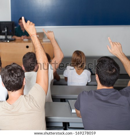 Students asking professor in classroom
