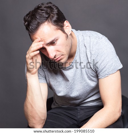 Man with depression sitting in gray shirt
